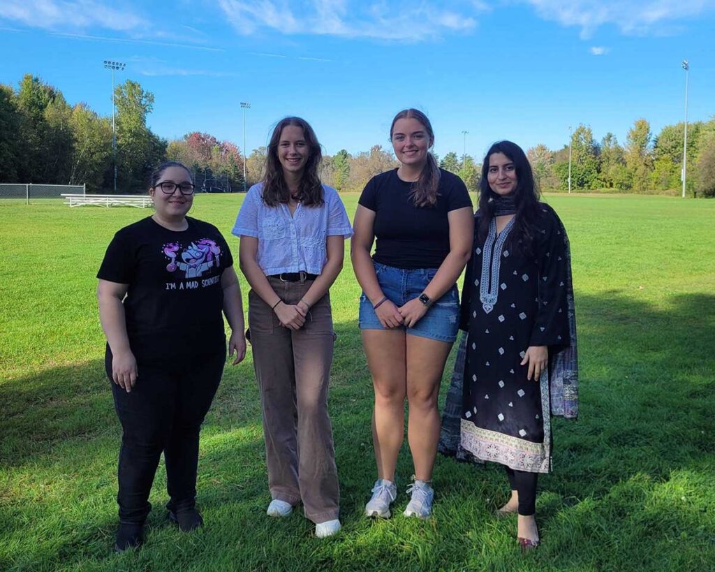 Lab group standing together for a photo outside on a sunny day