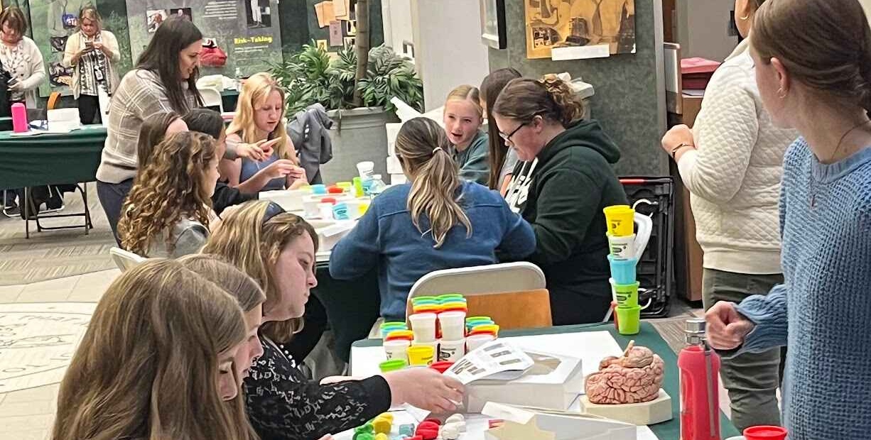 Photo of students and faculty working on educational activities.