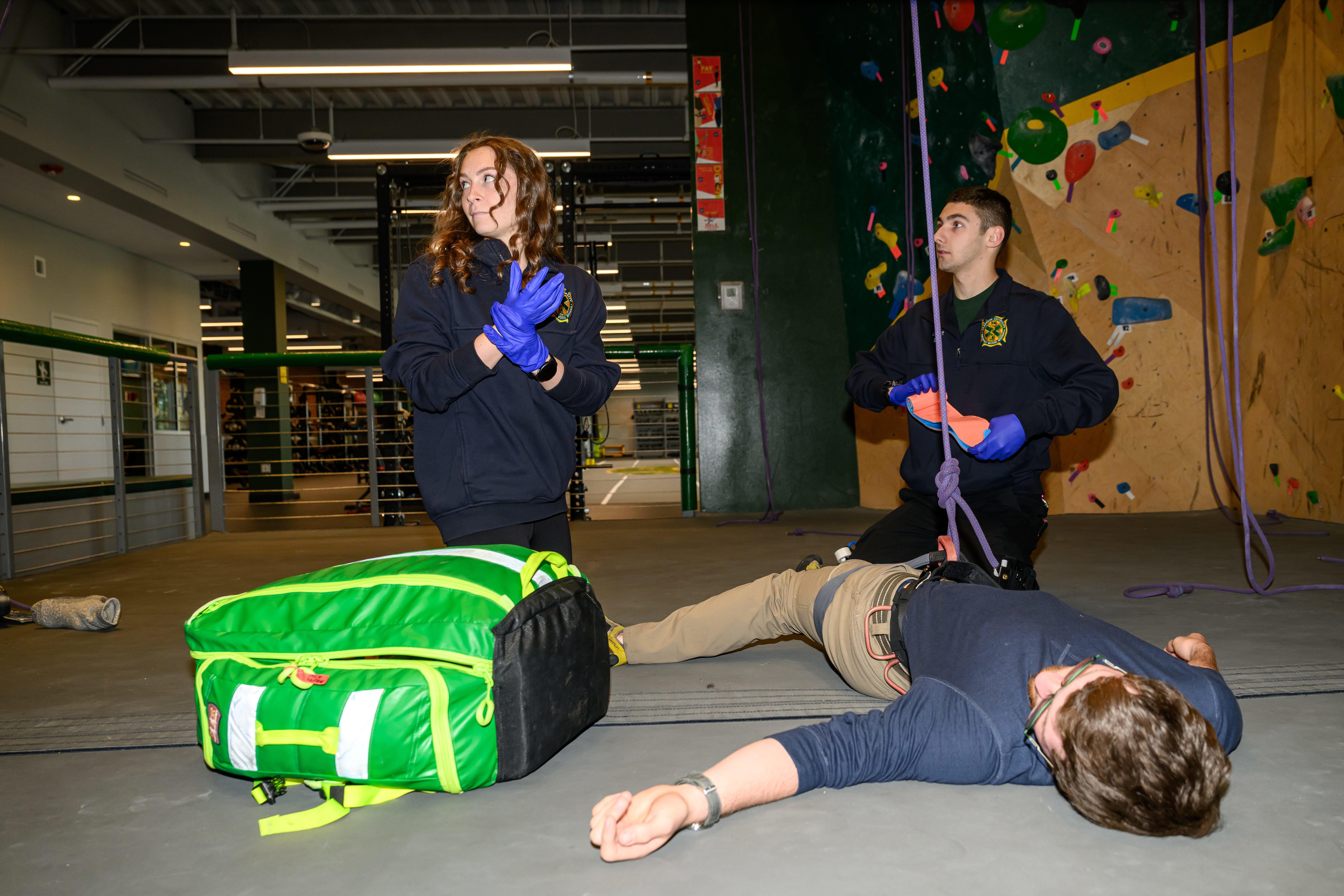 Two EMTs assist an injured person